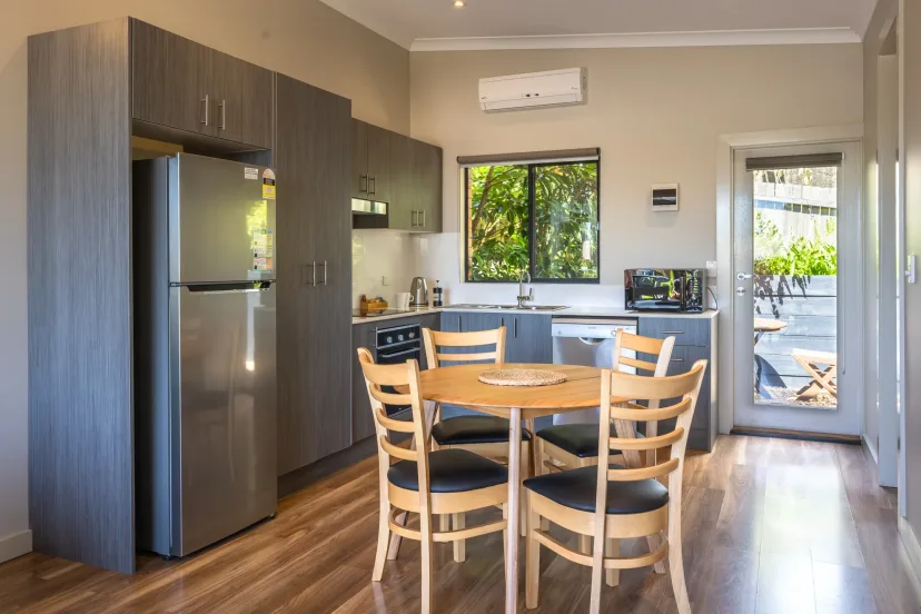 Apartment kitchen and dining area with a full-size fridge and seating for six