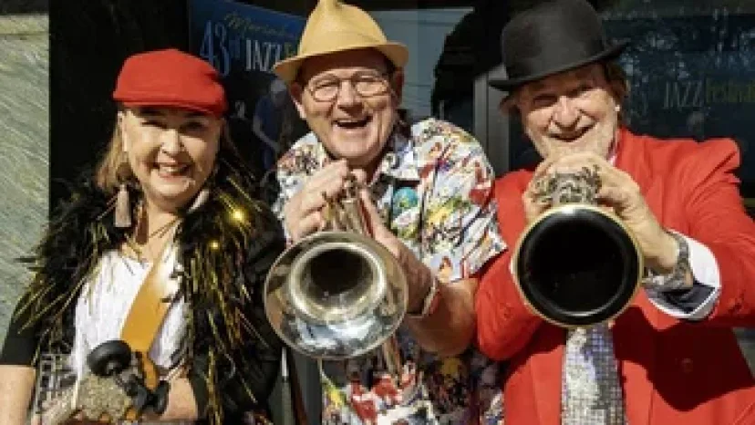 Three musicians in hats playing trumpet and saxophone at the Merimbula Jazz Festival